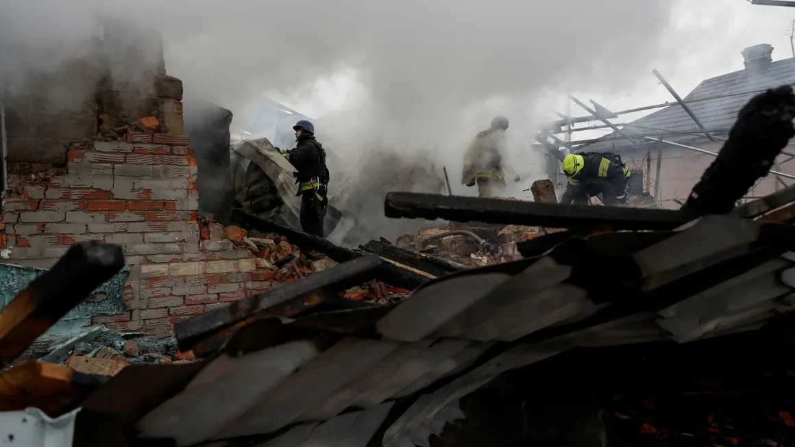 Firefighters work at the site of residential buildings hit by a Russian strike in Kharkiv, Ukraine, 